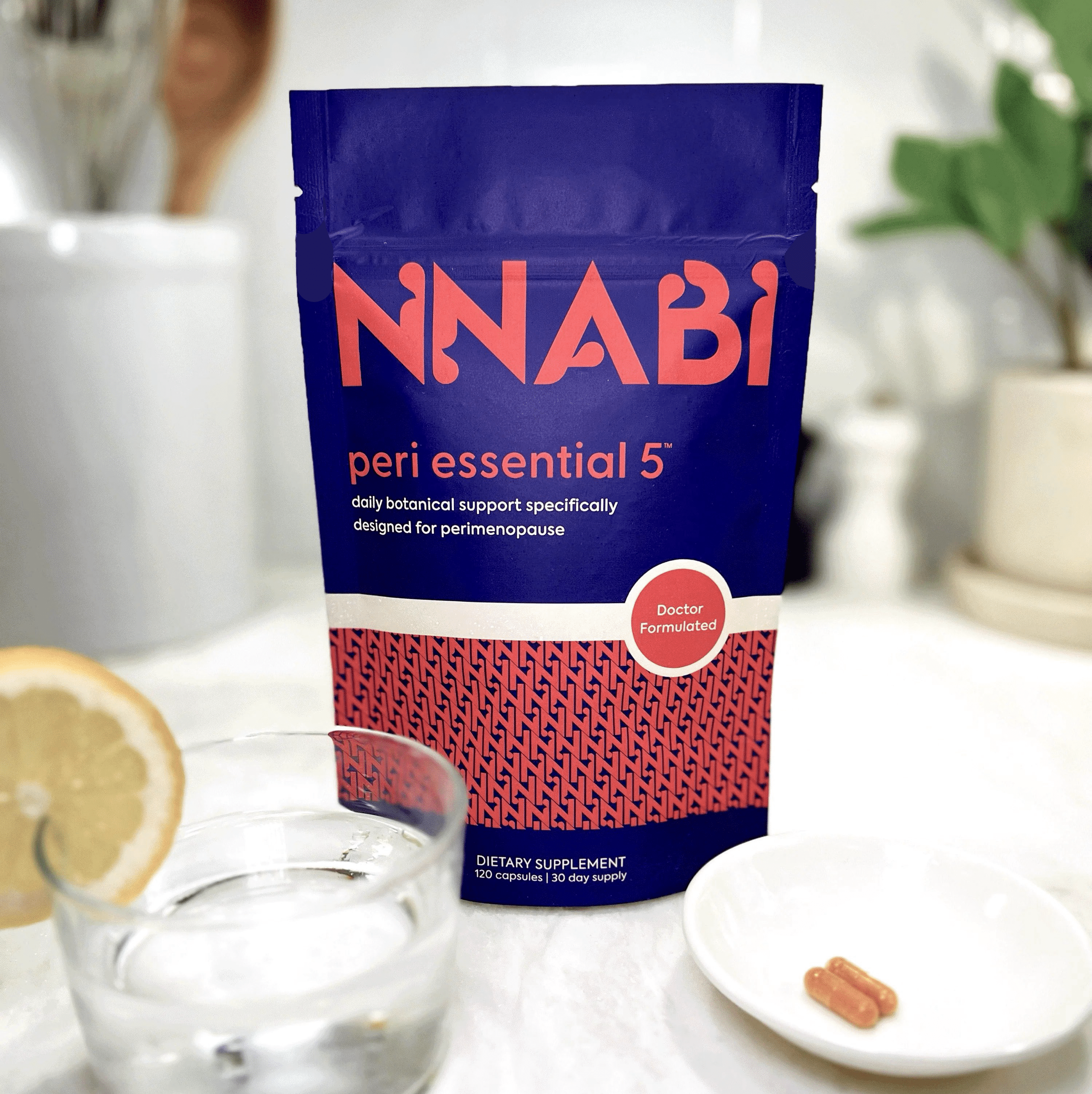 NNABI Peri Essential 5™ perimenopause supplement on kitchen counter with capsules